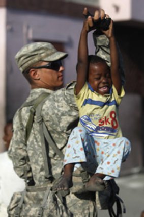 A US soldier with a Haitian child.