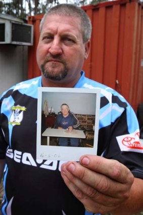 Wants closure ... Bill Stuttle holding a photograph of his father Bill, who died after the Quakers Hill nursing home fire.