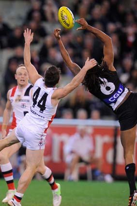 Harry O'Brien goes for a mark in the final moments against St Kilda while Stephen Milne (44) lurks.