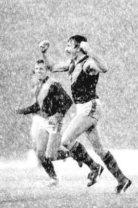 Tiger back pocket Mick Malthouse signals Richmond's eight goal win over Essendon at VFL Park, accompanied by Barry Rowlings, 1982.