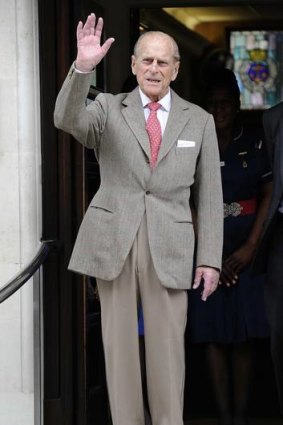 Prince Philip waves as he leaves the King Edward VII Hospital.
