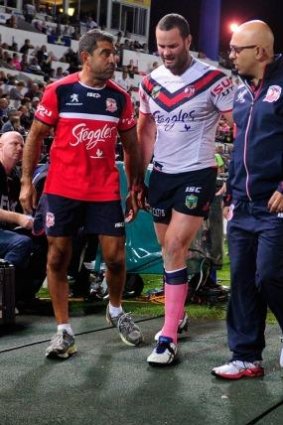 Roosters forward Boyd Cordner is helped from the field against North Queensland.
