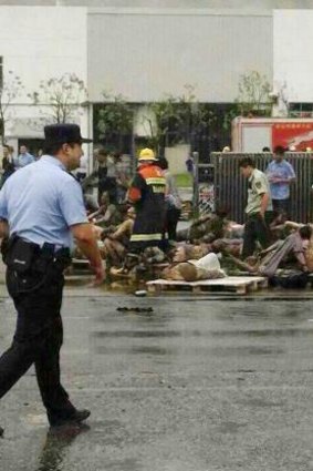 Emergency workers and injured people in front of the factory in Kunshan, China. 
