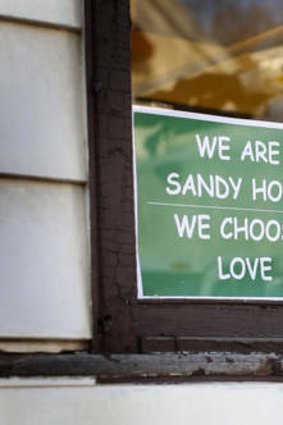 Message of support: The sign designed by Tim Stan has been popping up all over Sandy Hook.