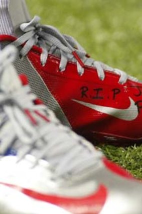 Tribute ... Victor Cruz inscribed Jack Pinto's name on his boots.