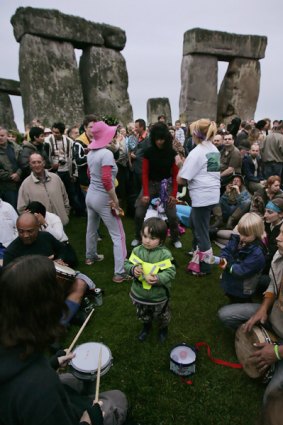 People dance at Stonehenge in celebration of the summer solstice.