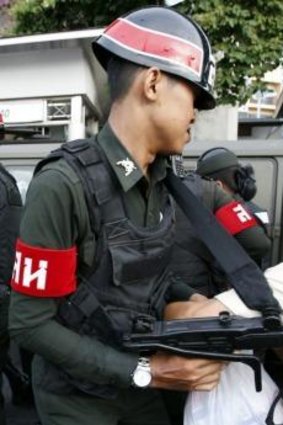 A protester scuffles with soldiers at Bangkok's Victory Monument.