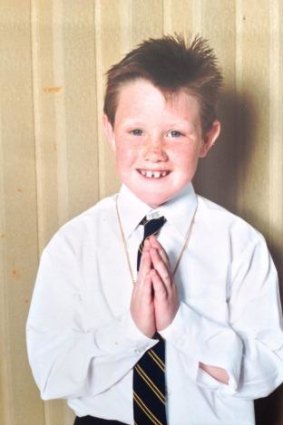 Eddie Perfect, 7, makes his first communion in 1985.