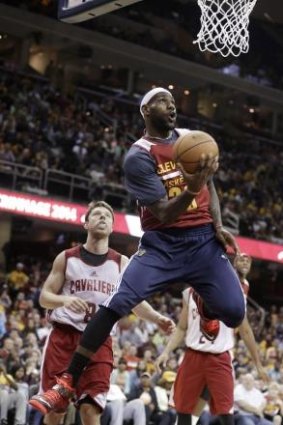 Up, up, up, he goes: LeBron  James takes it to the hoop with Boomers guard Matthew Dellavedova powerless to stop him.