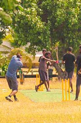 Newly arrived asylum seekers playing cricket on Cocos Island.