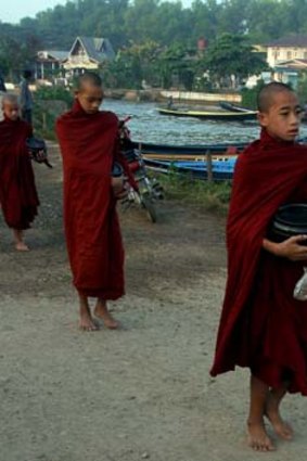 Young monks collect alms at Inle Lake.