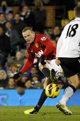 Decisive ... Wayne Rooney curls his shot around defender Aaron Hughes and in.