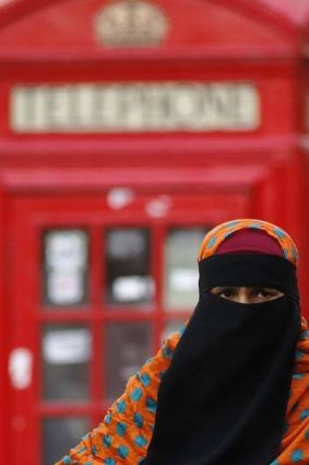 A woman wears a full-face veil as she shops in London. The British government is working out how to better integrate Britain's 2.7 million Muslims without restricting the right to freedom of religious expression.