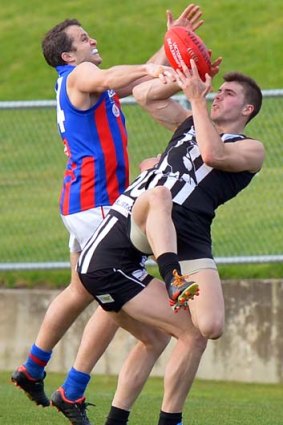 Close call: Magpie Tim Allan outmarks a Borough opponent.
