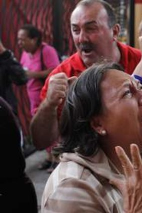 Tears of grief ...  Chavez supporters weep in the streets of Caracas.