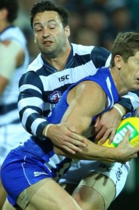 Hit and miss: Jimmy Bartel and Nick Dal Santo get to grips with each other.