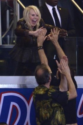 Shelly Sterling, wife of Donald Sterling, high fives fans in the final seconds of the Clippers defeat of the Golden State Warriors.