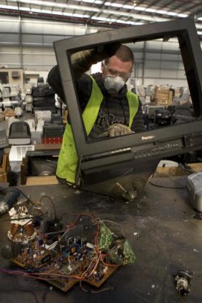 Steve Hamment disassembles a TV at the e waste TV recycling plant.