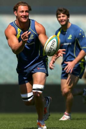 Scott Higginbotham slings a pass out during a Wallabies training session at Patersons Stadium yesterday.