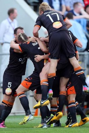 Onward and upward: Brisbane celebrate a goal on their way to securing a semi-final birth against Western Sydney Wanderers on Friday.