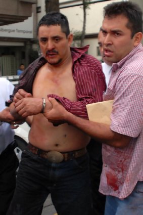 Luis Felipe Hernandez Castillo (left) is arrested by Mexican police after a shooting at Mexico City's subway,