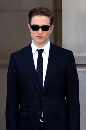 Robert Pattinson rocks a smooth style on set.
