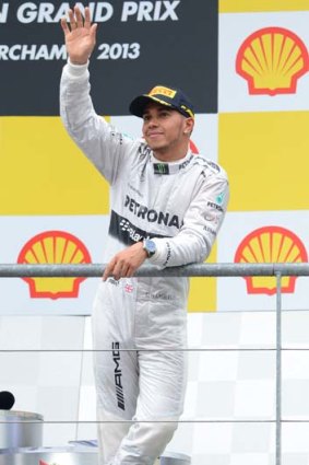 Lewis Hamilton waves from the podium after the Belgian Grand Prix.