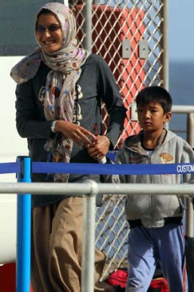 Happy to be here ... Malaysia deal asylum seekers arrive on Christmas Island.
