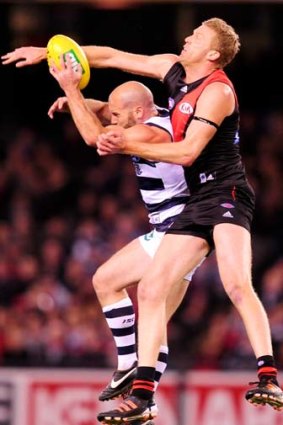 Stretching out: Geelong’s Paul Chapman attempts to mark in front of Dustin Fletcher last night.