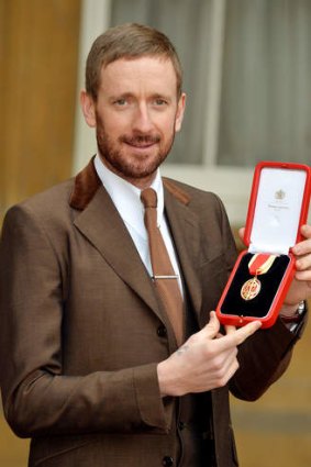 Sir Bradley Wiggins poses with his medal.