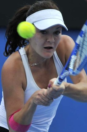 Agnieszka Radwanska of Poland in action against Simona Halep of Romania during their round three women's singles match.