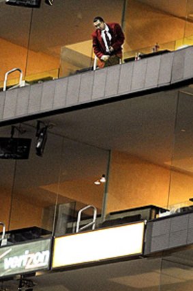 A security guard looks down from the balcony where a toddler fell at an LA Lakers NBA game.