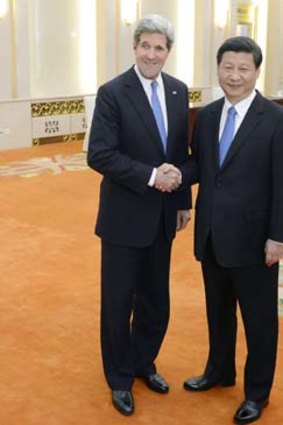 Working together: John Kerry greets Chinese President Xi Jinping.