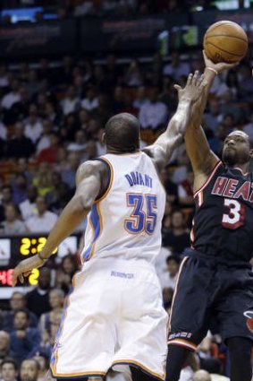 Miami Heat guard Dwyane Wade shoots over Oklahoma City Thunder small forward Kevin Durant.
