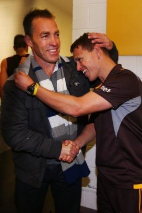 Alastair Clarkson, who is recovering from illness, hugs his stand-in Brendon Bolton, after the Hawks recorded their ninth win of the season.