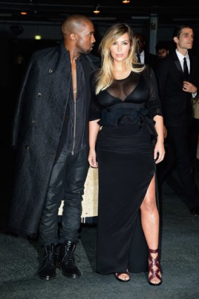Kim Kardashian and Kanye West arrive at the Givenchy show in Paris on September 29, 2013.