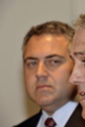 Malcolm Turnbull is watched by Joe Hockey as the two present a united front for the media yesterday.