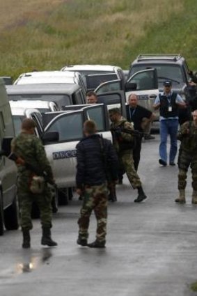Donetsk region: Pro-Russian separatists greet monitors from the Organisation for Security and Cooperation in Europe amid reports they are hampering the MH17 investigation.