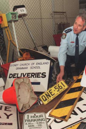 Inspector Bert Oosterhoff, pictured at North Sydney police station with items collected by SCEGGS Redlands students during a muck up day prank in 1997.