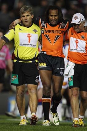 Yet another return ... Lote Tuqiri, pictured being helped from the field after injuring his leg in round 13, will be back for the Tigers against the Roosters on Saturday night.