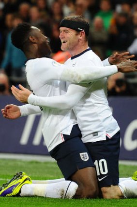 World Cup qualification beckons: Wayne Rooney and Danny Welbeck celebrate England's first goal.