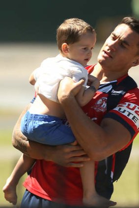 Sitting it out: Sonny Bill Williams with a young fan at training on Wednesday.