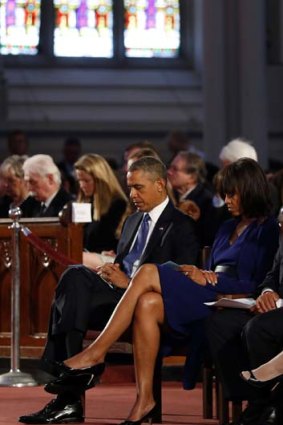 Honouring the victims: President Barack Obama with Michelle Obama at the memorial service.