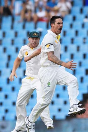 Australia's bowler Mitchell Johnson, right, with teammate David Warner, left, reacts after dismissing South Africa's batsman Faf du Plessis.
