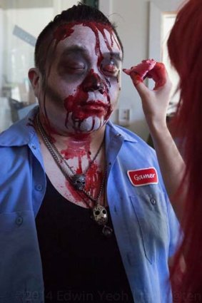 Make-up is put on a zombie actor.