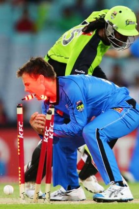 Combustible ... Johan Botha of the Thunder lights up the bails when trying to run out the Strikers' Chris Gayle.