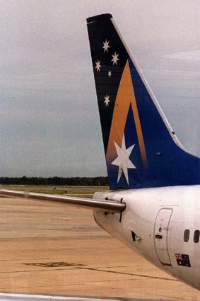 Tail of woe ... an Ansett ground crew member sits on a freight conveyor after news of the airline's closure in the aftermath of the September 11 terrorist attacks.