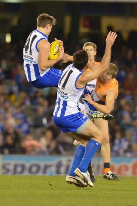 North Melbourne's Aaron Mullett marking over Greater Western Sydney's Devon Smith.