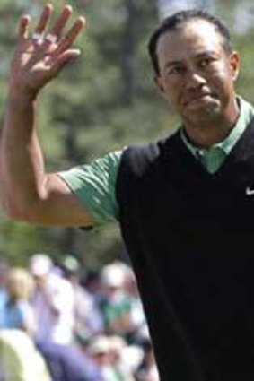 Tiger Woods acknowledges applause from the crowd at the 18th after completing his second round at the US Masters.