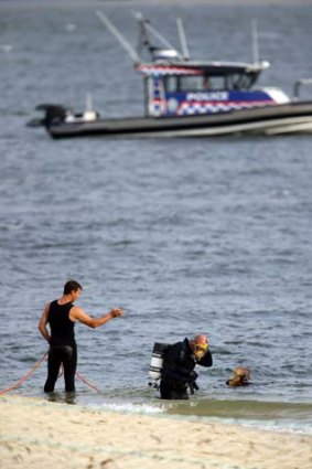 Search: divers prepare to enter the water.